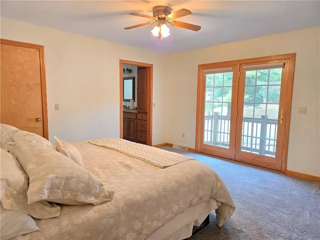 a bedroom with a large bed and a window