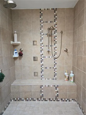 a bathroom with a bathtub and shower