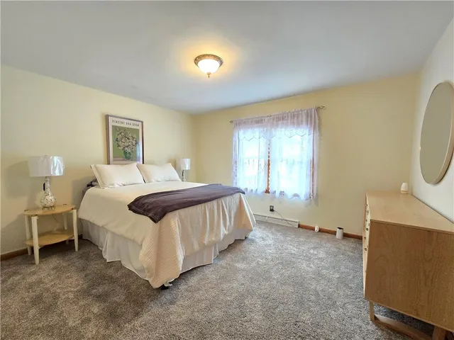 a spacious bedroom with a bed and a window