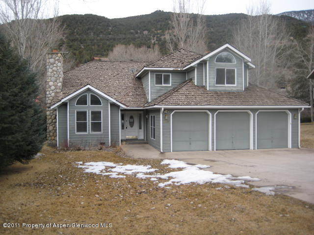 330 Riverside Drive Basalt, CO 81621 - Photo 1 of 9 a front view of a house with a yard and garage