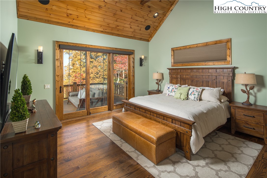 331 Goldenrod Road Boone, NC 28607 - Photo 15 of 50 a bedroom with a large bed and a potted plant