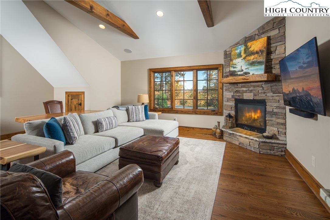 331 Goldenrod Road Boone, NC 28607 - Photo 22 of 50 a living room with furniture a fireplace and a flat screen tv