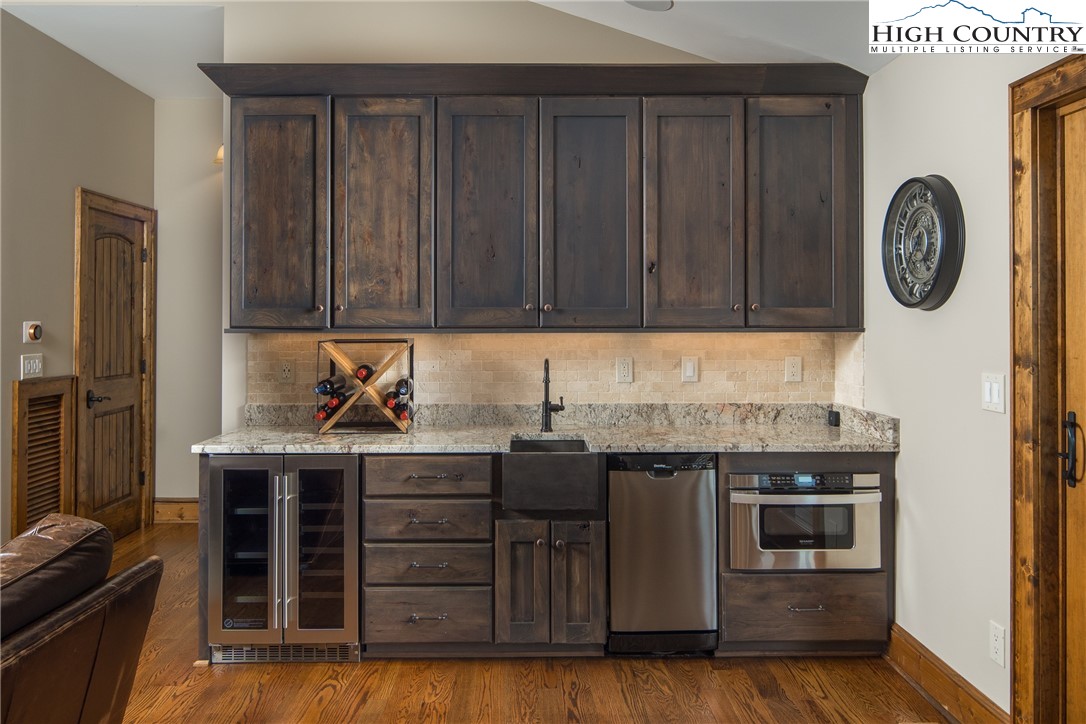331 Goldenrod Road Boone, NC 28607 - Photo 24 of 50 a kitchen with stainless steel appliances granite countertop a stove and a refrigerator with wooden cabinets