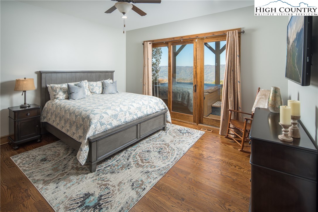 331 Goldenrod Road Boone, NC 28607 - Photo 33 of 50 a bedroom with a bed a flat screen tv and a large window