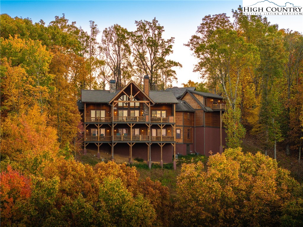 331 Goldenrod Road Boone, NC 28607 - Photo 41 of 50 a view of a chairs and table in the patio next to a yard
