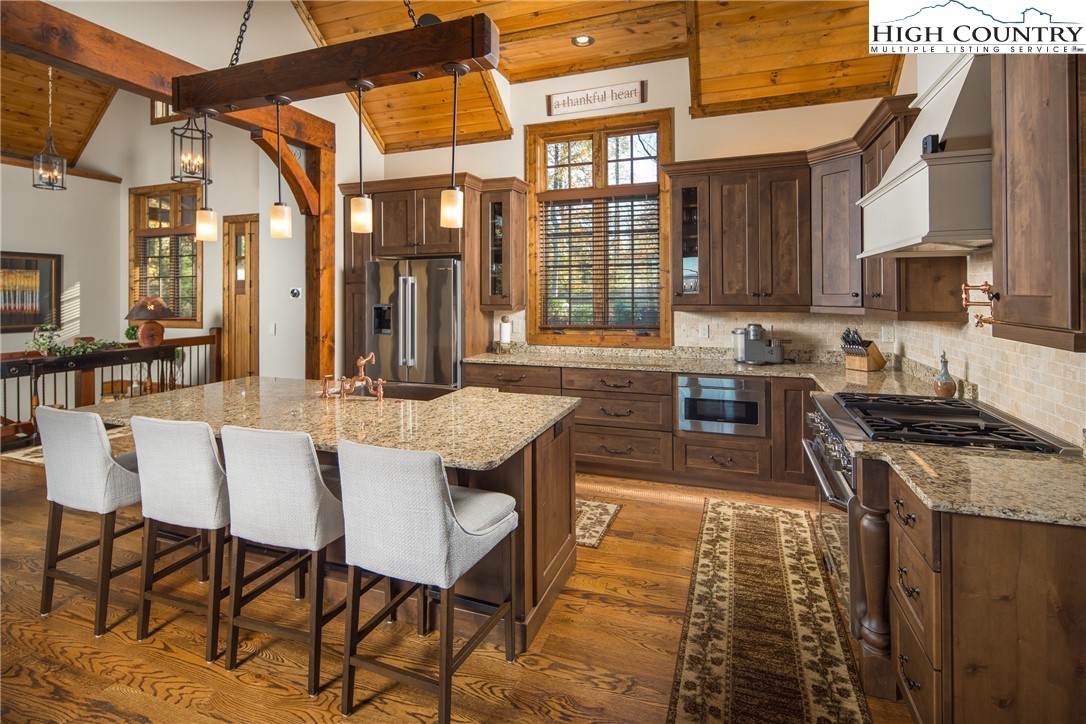 331 Goldenrod Road Boone, NC 28607 - Photo 7 of 50 a kitchen with a stove a sink and cabinets