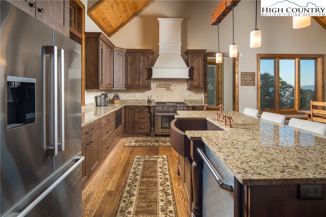 331 Goldenrod Road Boone, NC 28607 - Photo 9 of 50 a kitchen with stainless steel appliances granite countertop sink stove refrigerator and cabinets