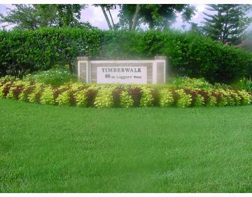 22295 Misty Woods Way, Unit 62B Boca Raton, FL 33428 - Photo 1 of 25 a sign that is sitting in the grass next to a road