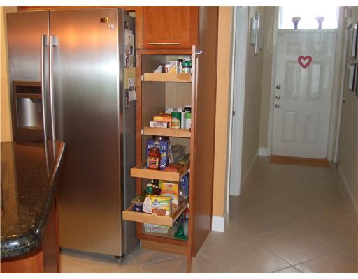22295 Misty Woods Way, Unit 62B Boca Raton, FL 33428 - Photo 3 of 25 a view of a kitchen from the hallway