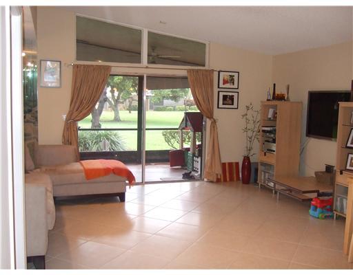 22295 Misty Woods Way, Unit 62B Boca Raton, FL 33428 - Photo 9 of 25 a view of a livingroom with furniture and a flat screen tv
