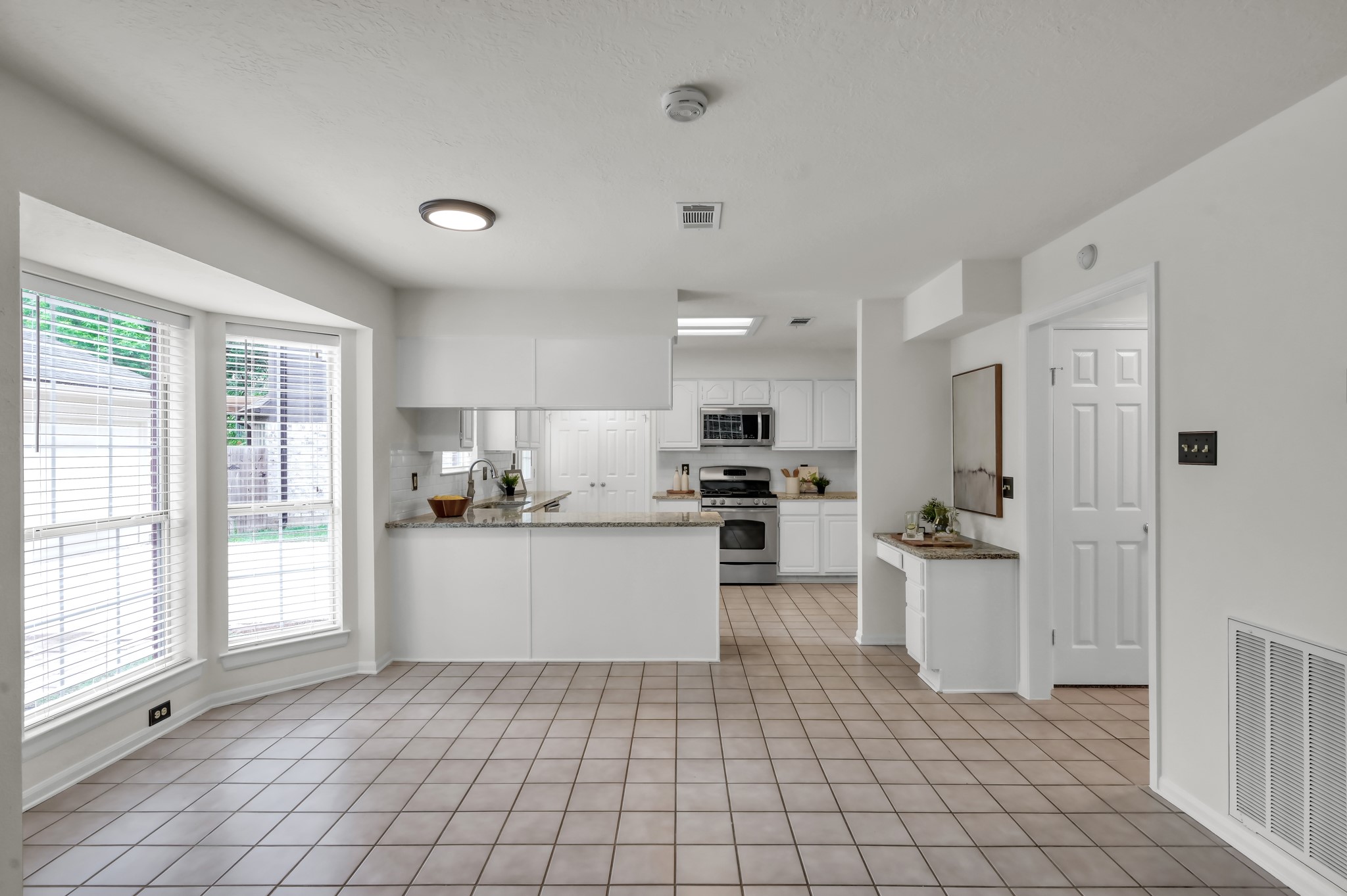114 Regency Way Conroe, TX 77304 - Photo 20 of 48 Large breakfast area looking out to the backyard and open to kitchen and living room.
