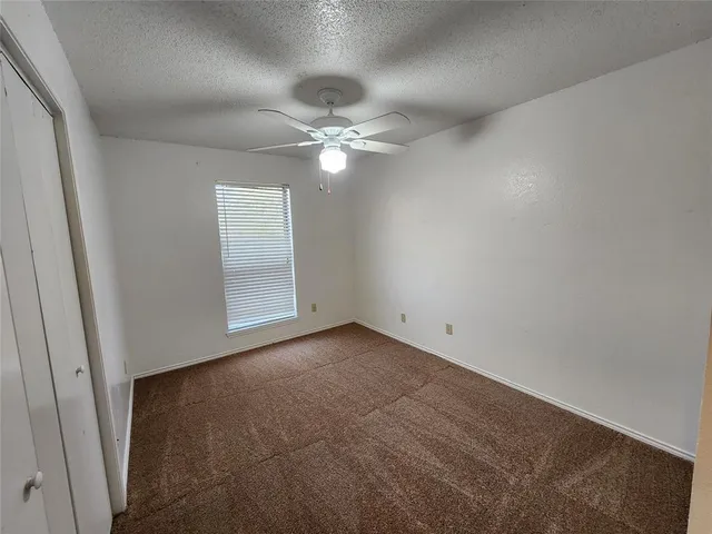 a view of an empty room with a fan