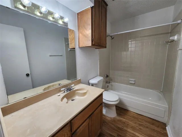 an empty room with closet and a chandelier fan