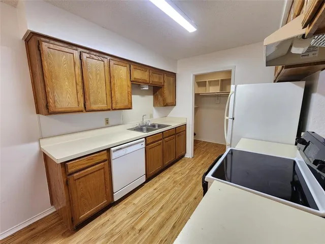 a kitchen with wooden cabinets and a sink