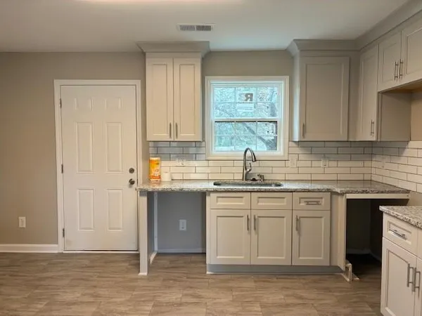 a kitchen with a sink cabinets and window