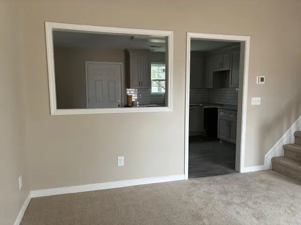 a view of an empty room with a window