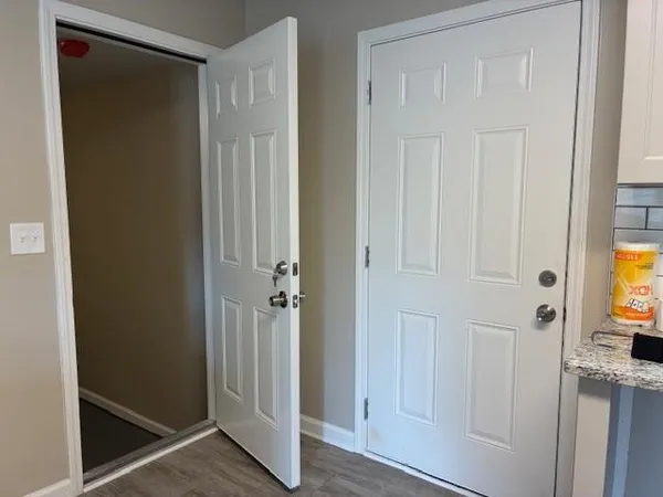 a kitchen with stainless steel appliances granite countertop a sink and cabinets with wooden floor