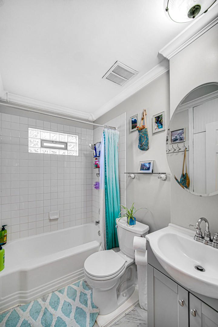 1308 Manchester Road Wheaton, IL 60187 - Photo 13 of 30 a bathroom with a sink toilet and shower