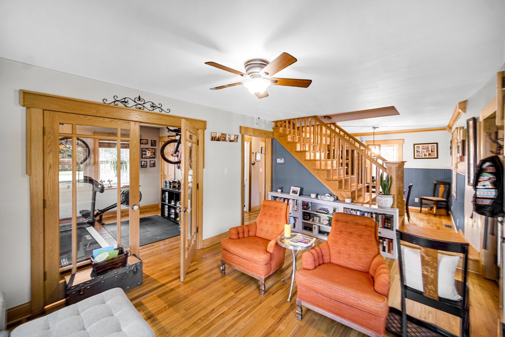 1308 Manchester Road Wheaton, IL 60187 - Photo 6 of 30 a living room with couches a dining table and chairs with wooden floor