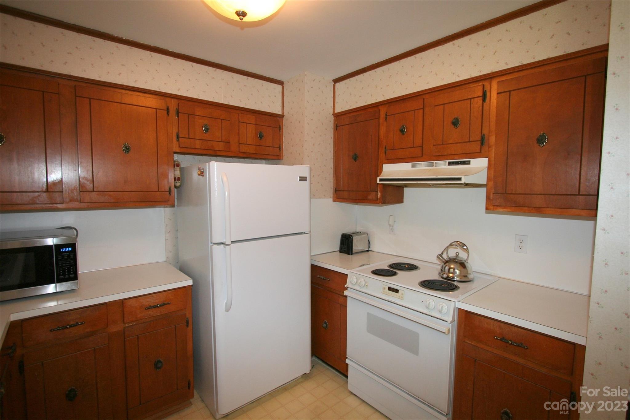 2813 Castlebrook Drive Monroe, NC 28112 - Photo 11 of 37 a kitchen with stainless steel appliances a refrigerator sink and cabinets