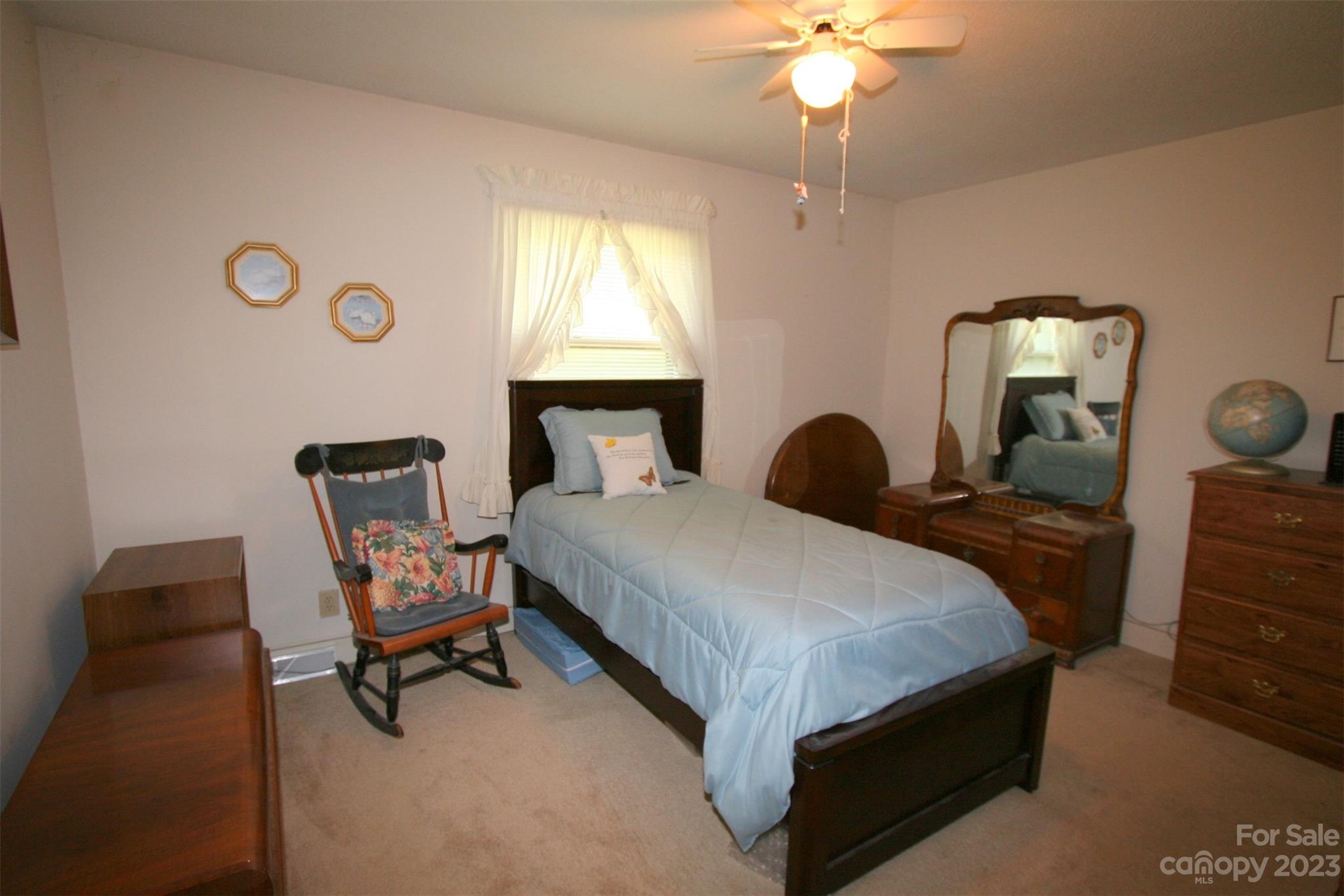 2813 Castlebrook Drive Monroe, NC 28112 - Photo 18 of 37 a bedroom with a bed a chair and a chandelier