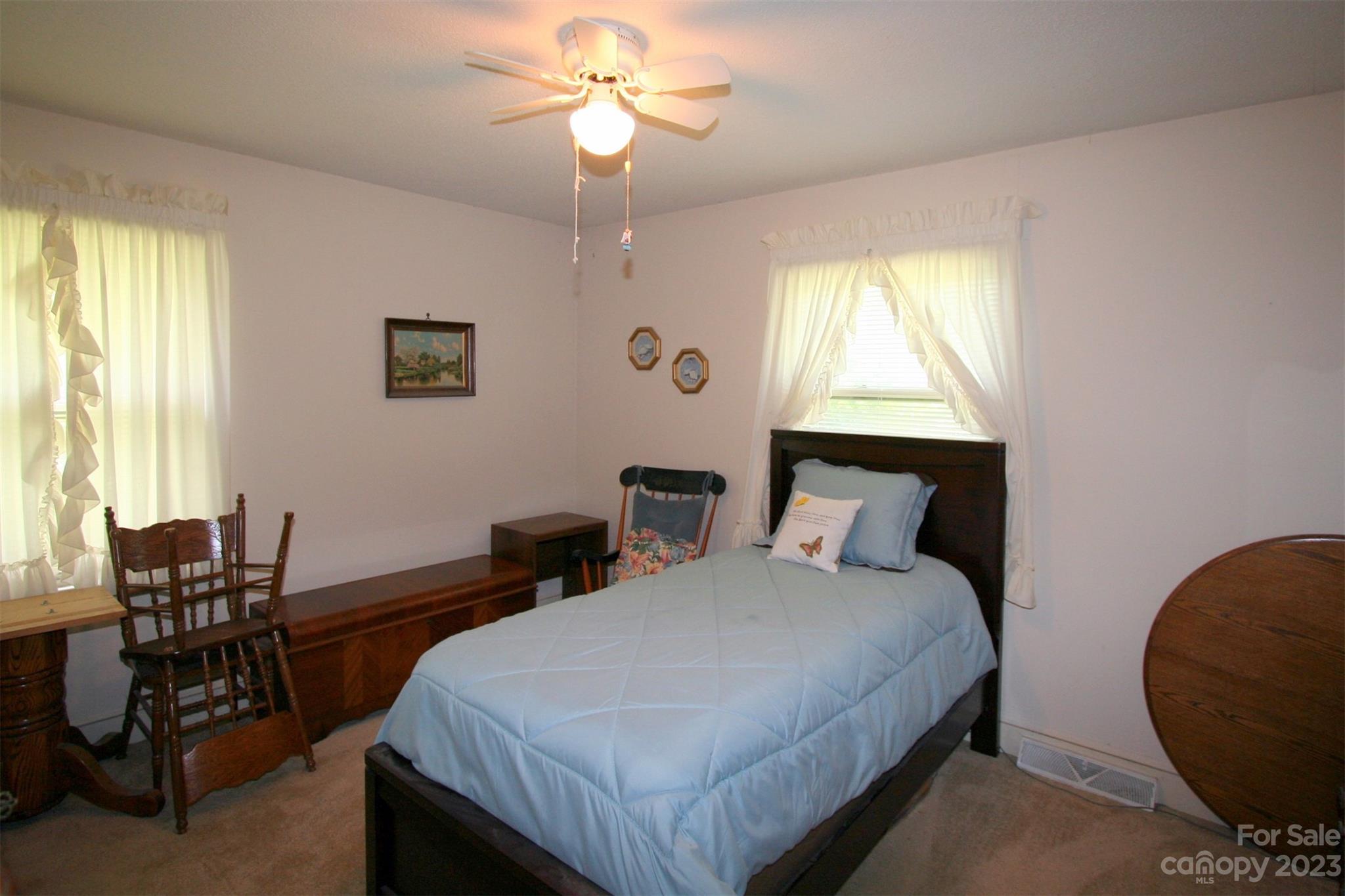 2813 Castlebrook Drive Monroe, NC 28112 - Photo 19 of 37 a bedroom with bed and a chandelier