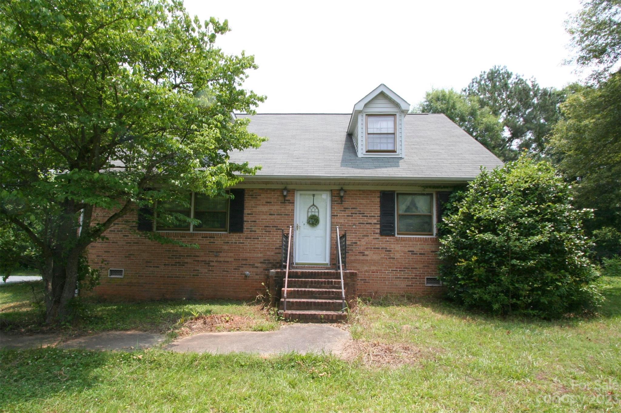 2813 Castlebrook Drive Monroe, NC 28112 - Photo 2 of 37 a front view of a house with garden