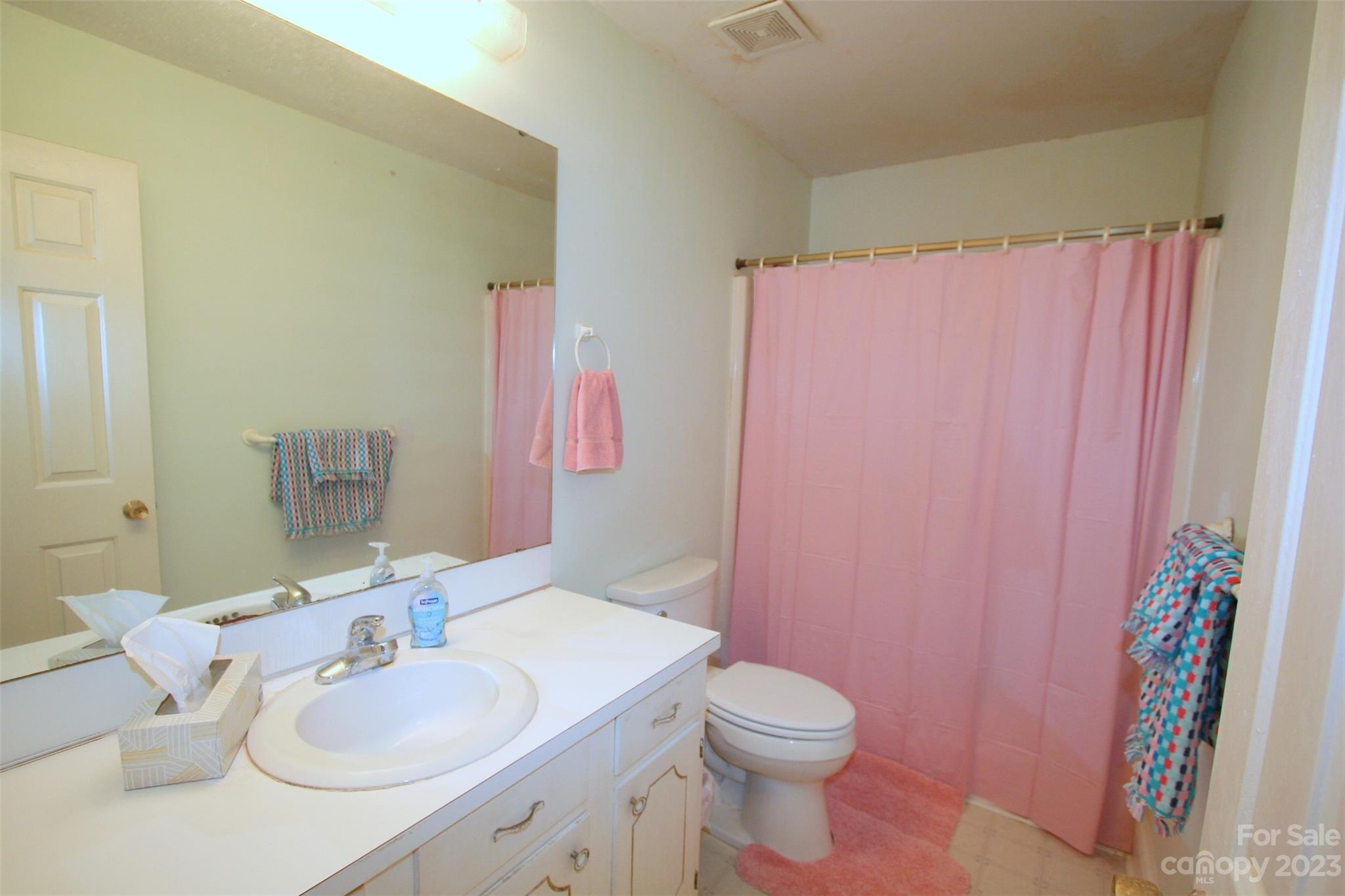 2813 Castlebrook Drive Monroe, NC 28112 - Photo 23 of 37 a bathroom with a sink vanity mirror and toilet