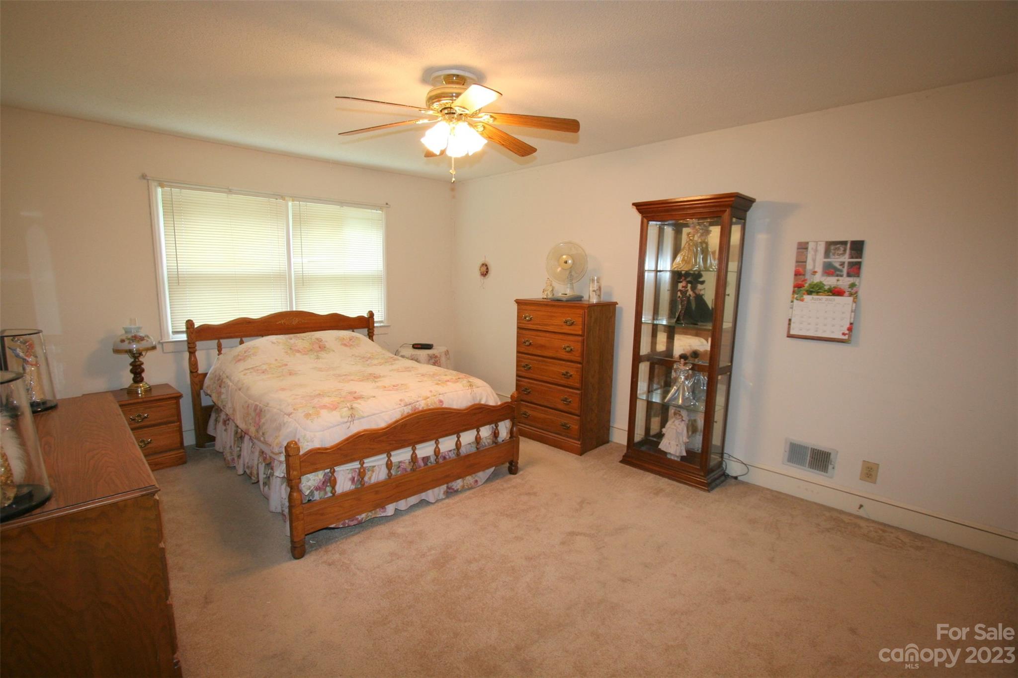 2813 Castlebrook Drive Monroe, NC 28112 - Photo 24 of 37 a bedroom with a bed and a chandelier