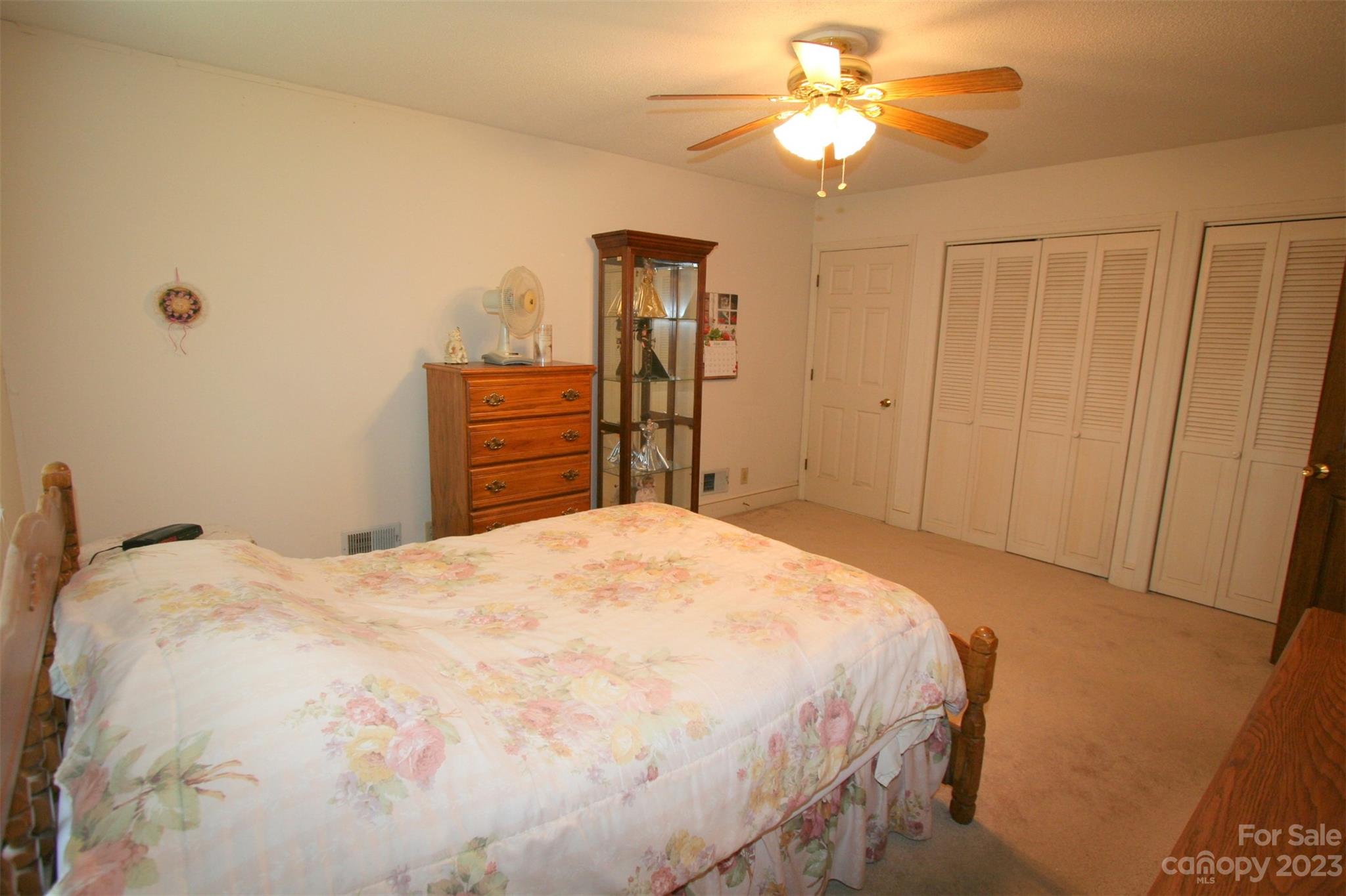 2813 Castlebrook Drive Monroe, NC 28112 - Photo 25 of 37 a bedroom with a bed and a chandelier