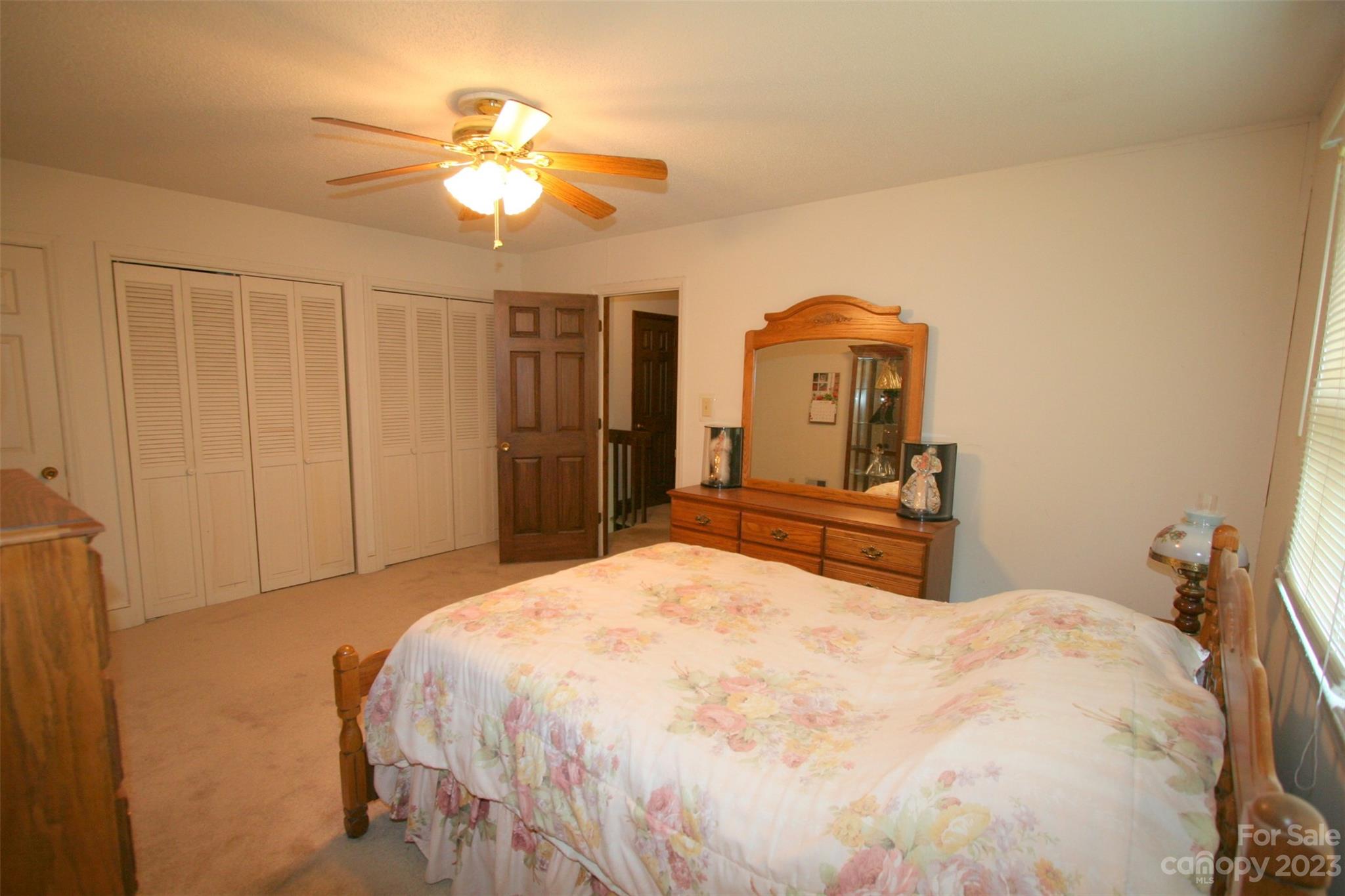 2813 Castlebrook Drive Monroe, NC 28112 - Photo 26 of 37 a bedroom with a bed and a chandelier
