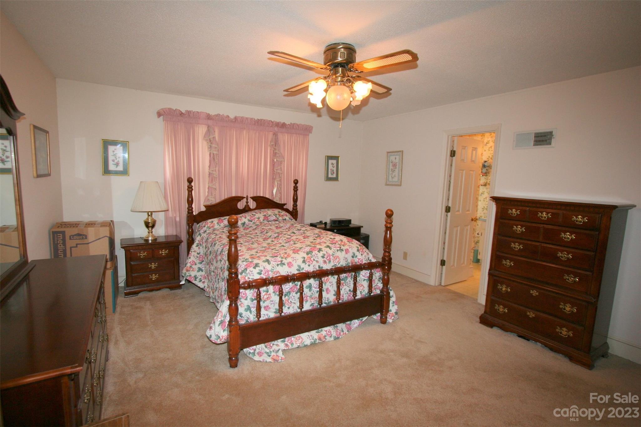 2813 Castlebrook Drive Monroe, NC 28112 - Photo 30 of 37 a bedroom with a bed and a chandelier