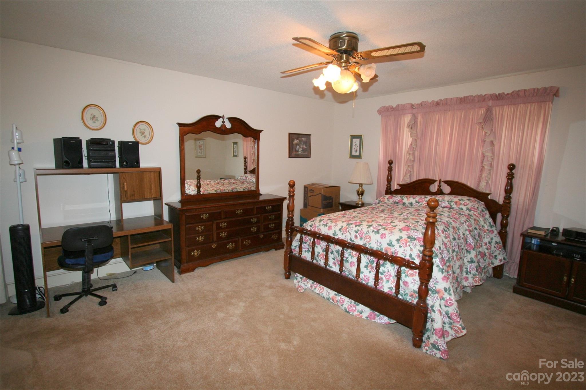 2813 Castlebrook Drive Monroe, NC 28112 - Photo 31 of 37 a bedroom with a bed and a chandelier