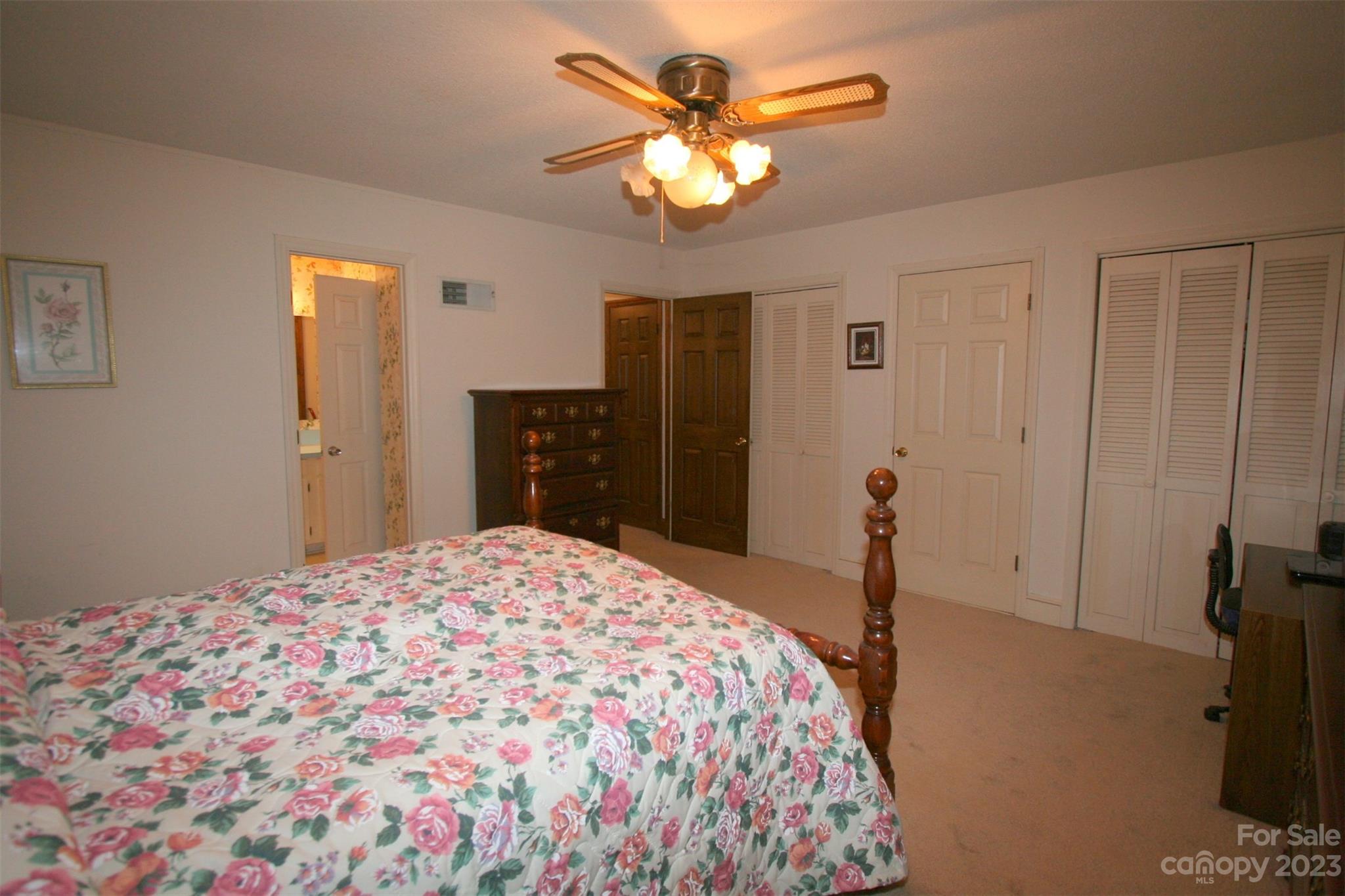 2813 Castlebrook Drive Monroe, NC 28112 - Photo 32 of 37 a bedroom with a bed and a chandelier