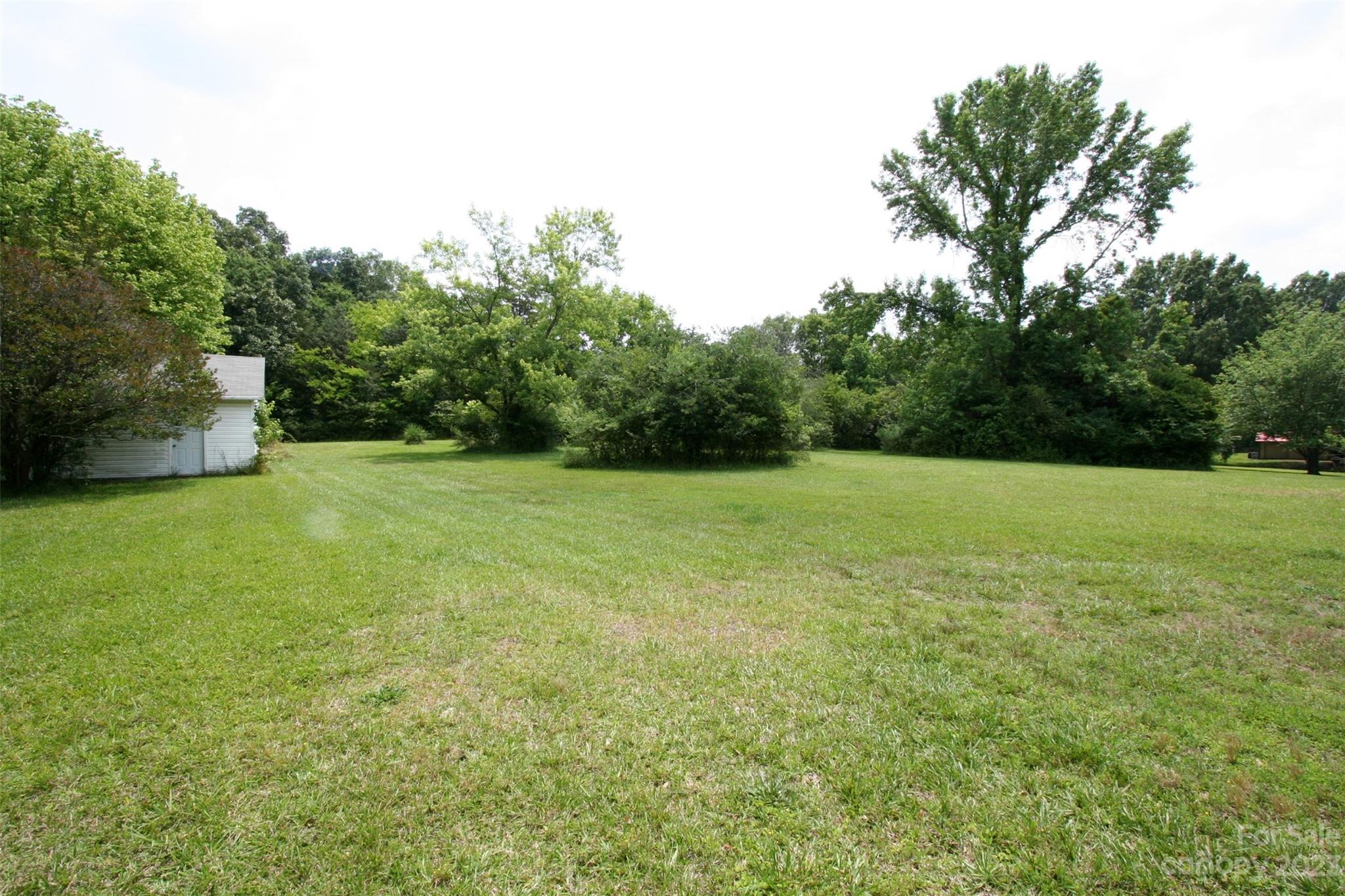 2813 Castlebrook Drive Monroe, NC 28112 - Photo 35 of 37 a view of a green field with trees in the background