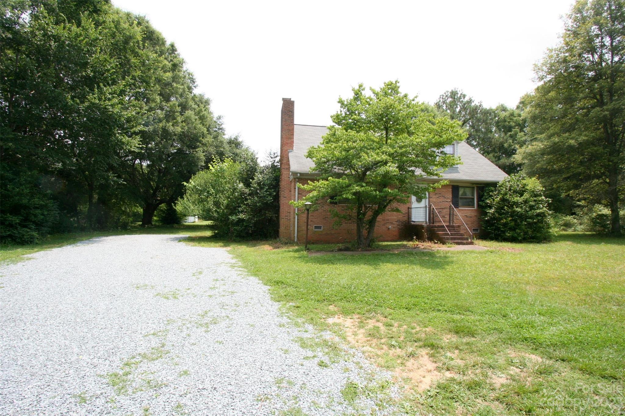 2813 Castlebrook Drive Monroe, NC 28112 - Photo 4 of 37 a front view of a house with a yard and trees