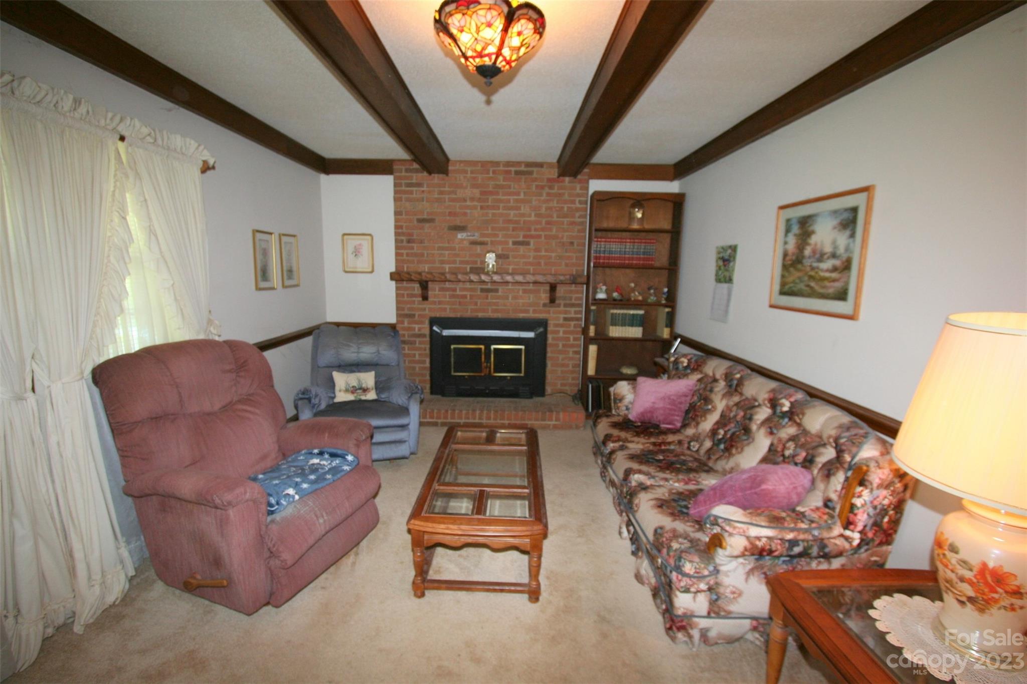 2813 Castlebrook Drive Monroe, NC 28112 - Photo 7 of 37 a living room with furniture a flat screen tv and a fireplace