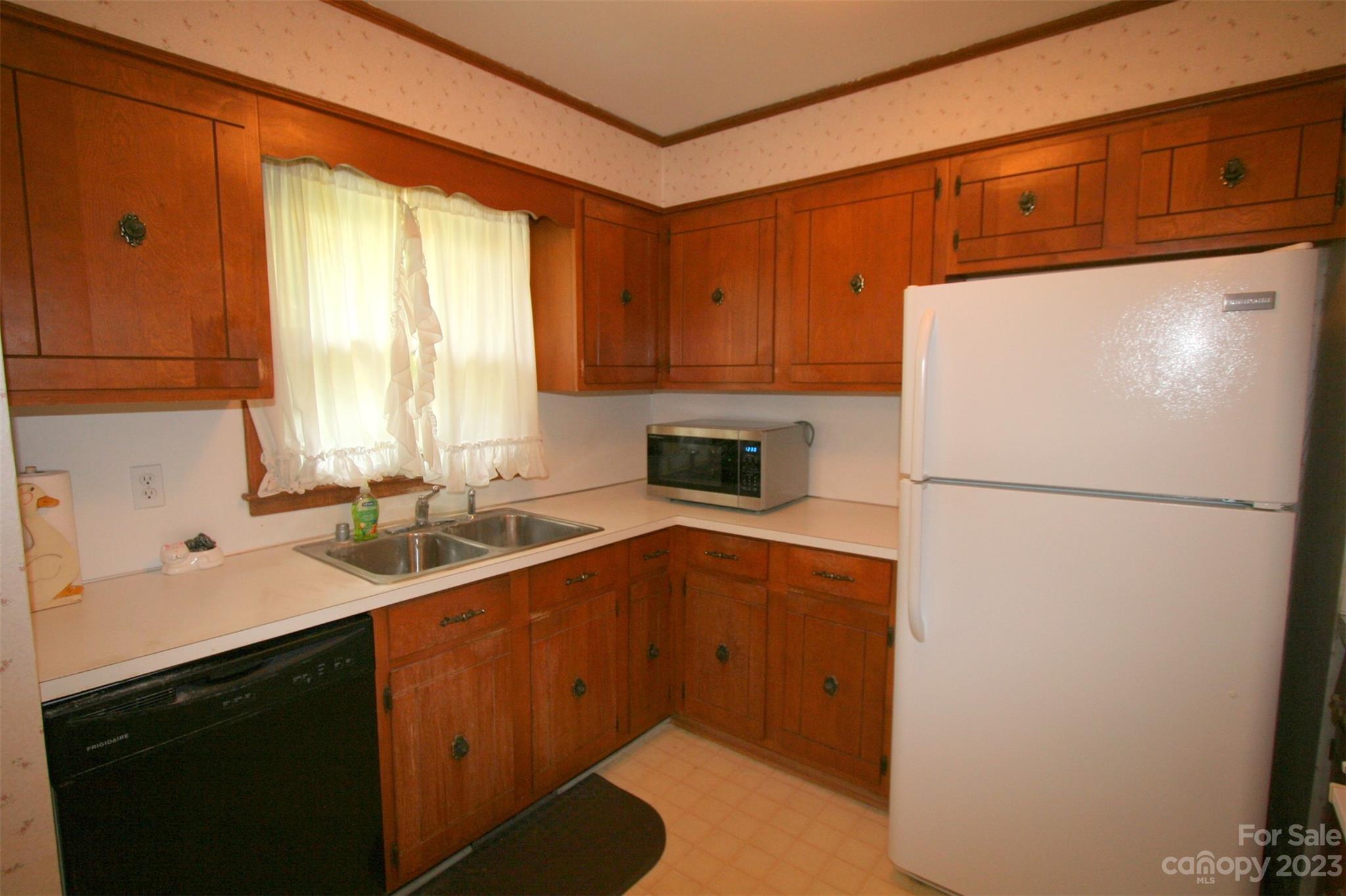 2813 Castlebrook Drive Monroe, NC 28112 - Photo 9 of 37 a kitchen with a refrigerator sink and cabinets