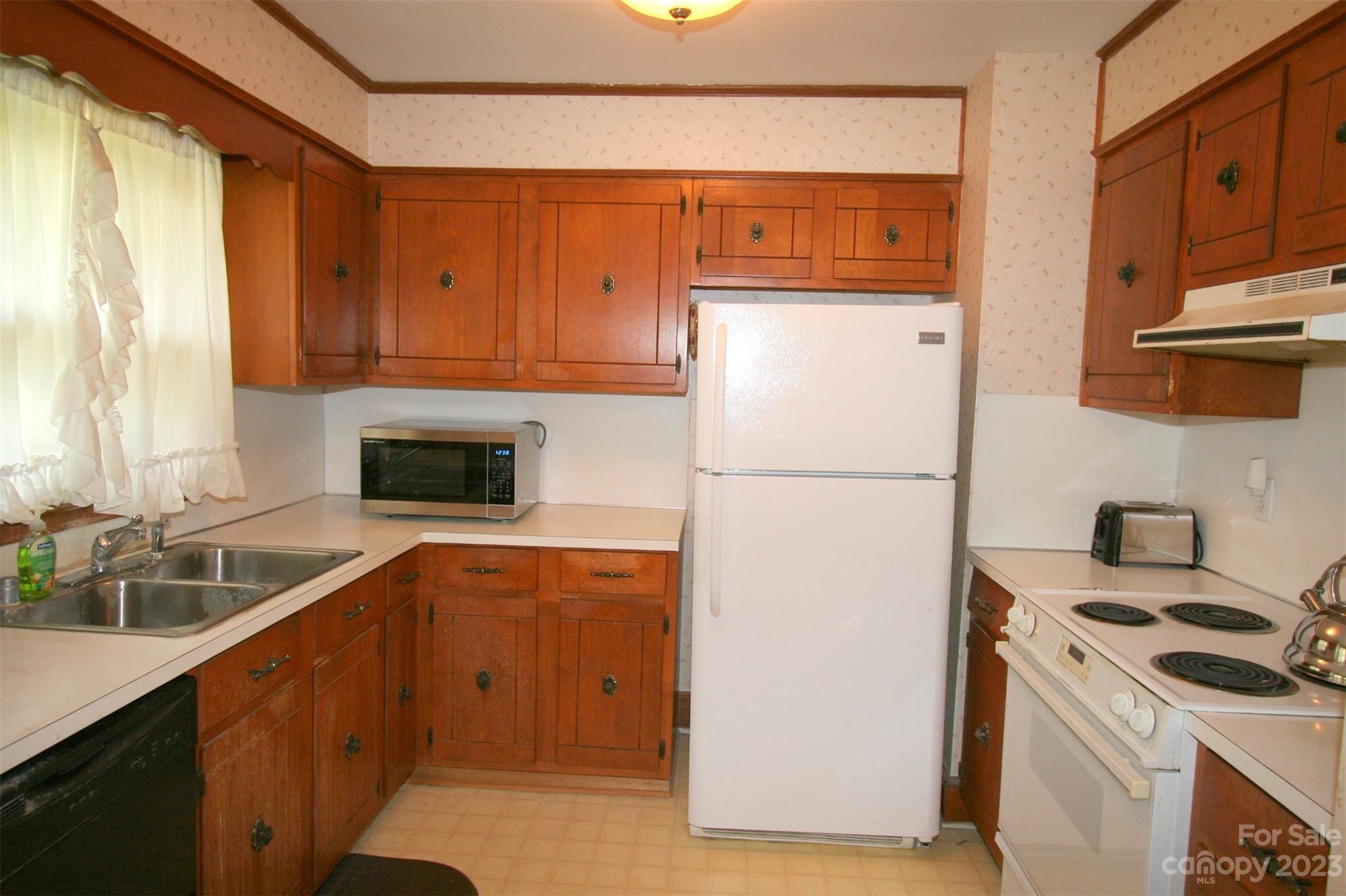 2813 Castlebrook Drive Monroe, NC 28112 - Photo 10 of 37 a kitchen with stainless steel appliances a refrigerator a stove a sink and a cabinets