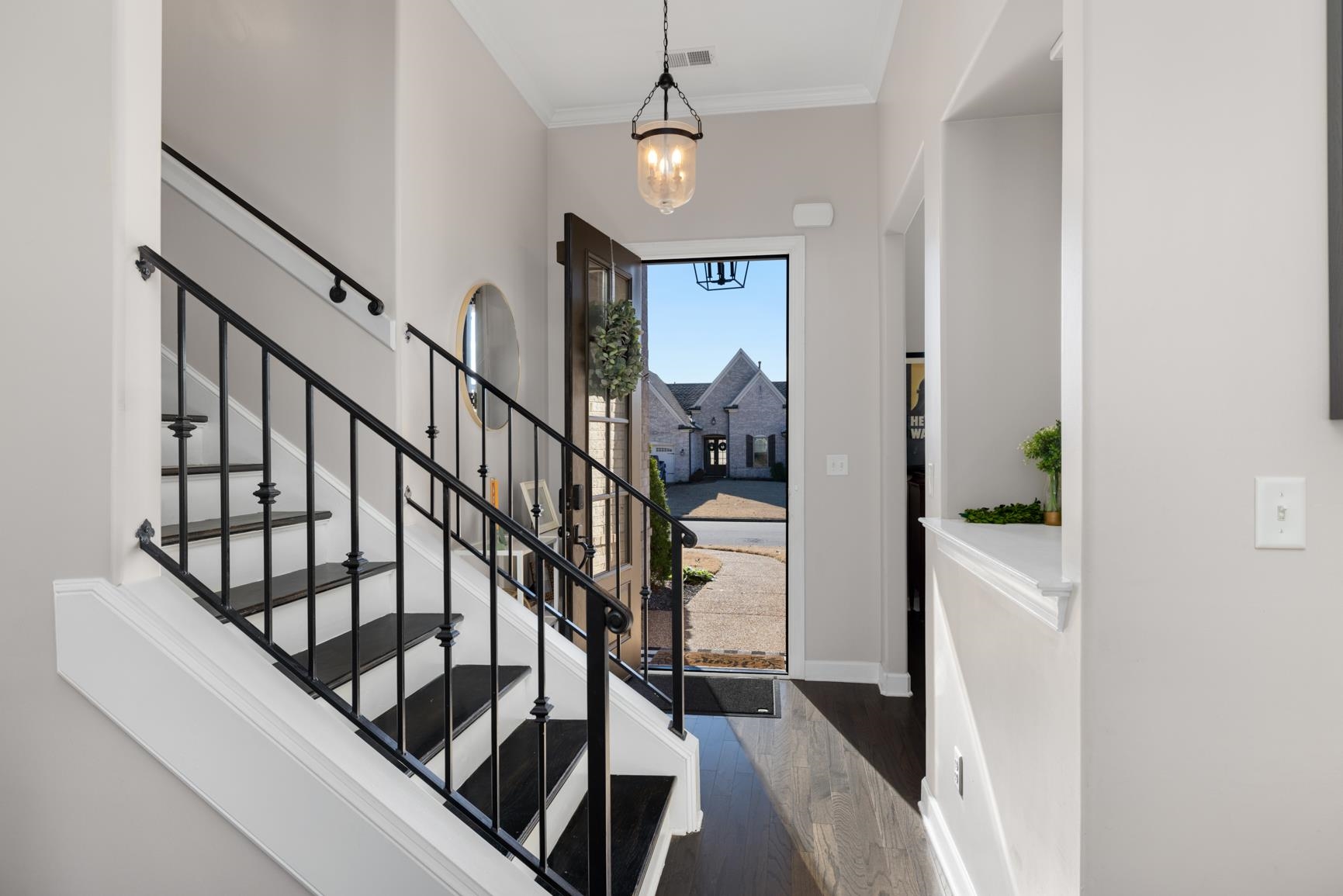235 Misty Fields Road Oakland, TN 38060 - Photo 6 of 40 Foyer entrance featuring crown molding, stairway, dark wood finished floors, and a chandelier