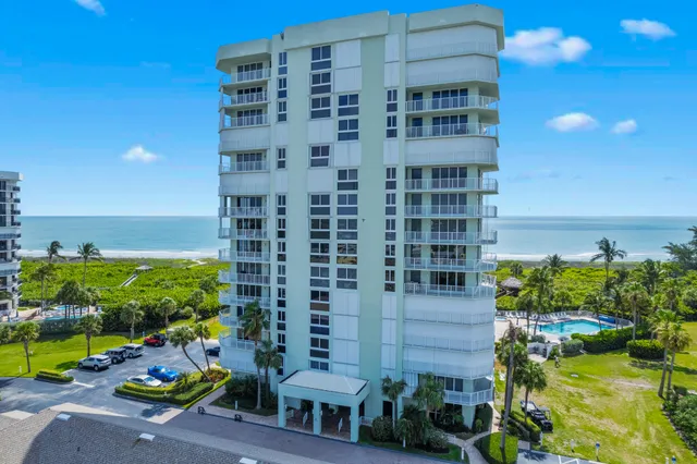 a front view of a building with a garden