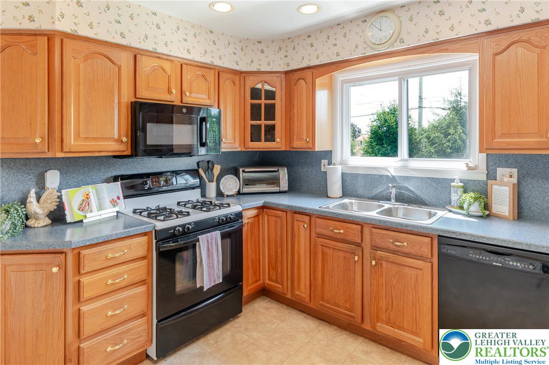 2130 Wisteria Road Lower Macungie Township, PA 18062 - Photo 16 of 48 A classic kitchen with abundant cabinet space and a double window above the double sink.