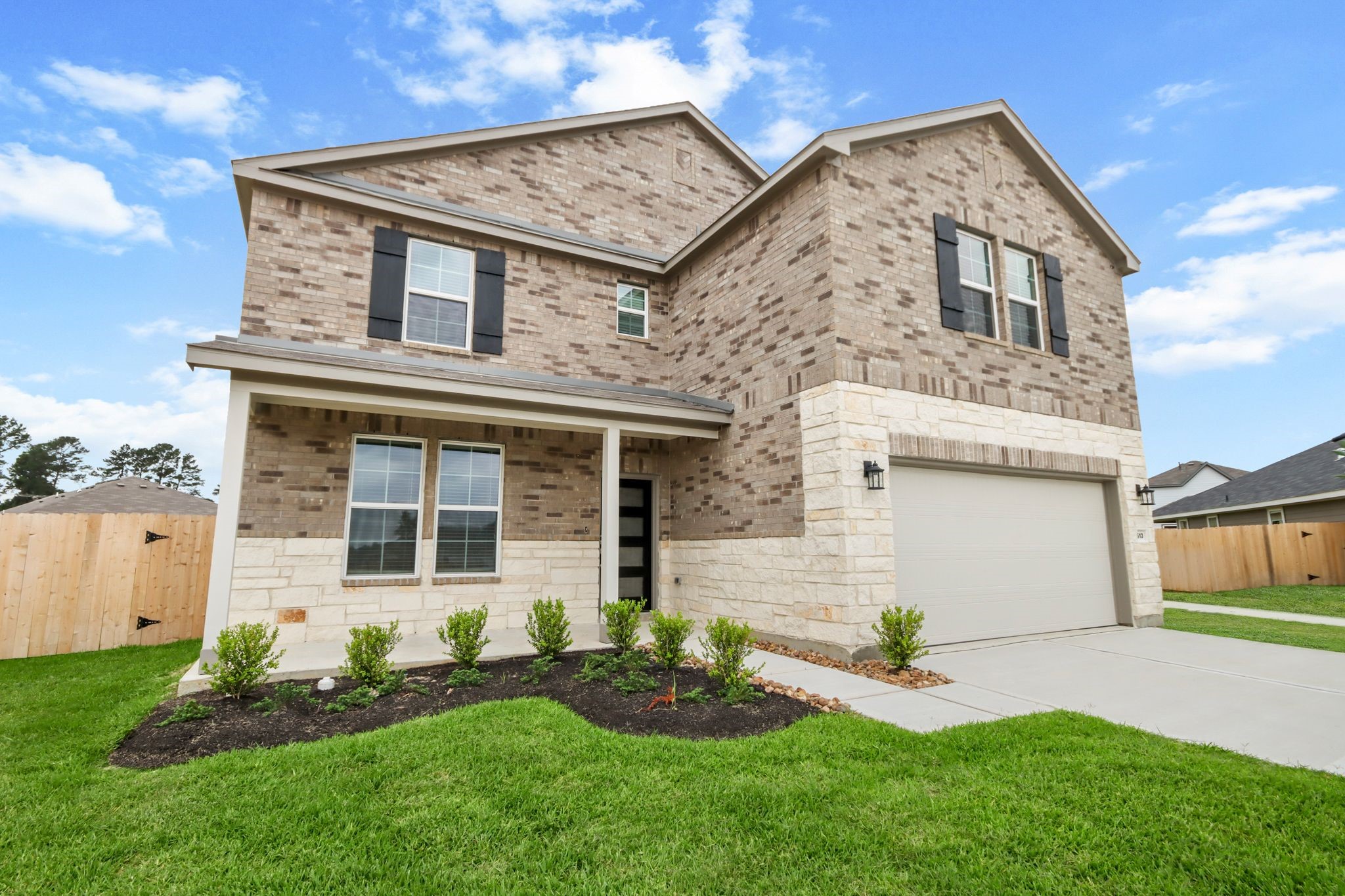 513 Wax Myrtle Way Hockley, TX 77447 - Photo 2 of 29 a front view of a house with a garden and plants