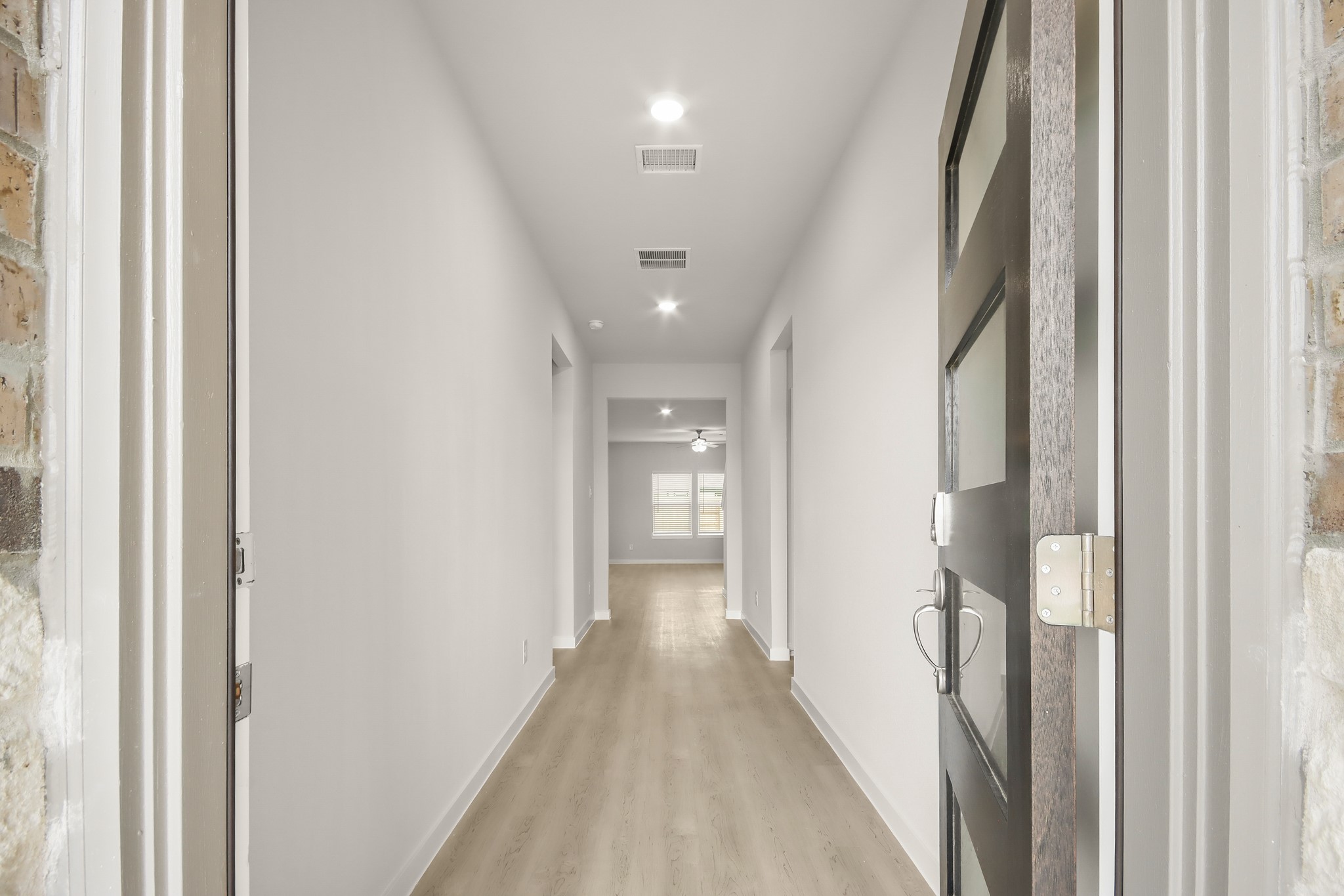 513 Wax Myrtle Way Hockley, TX 77447 - Photo 5 of 29 a view of a hallway with wooden floor