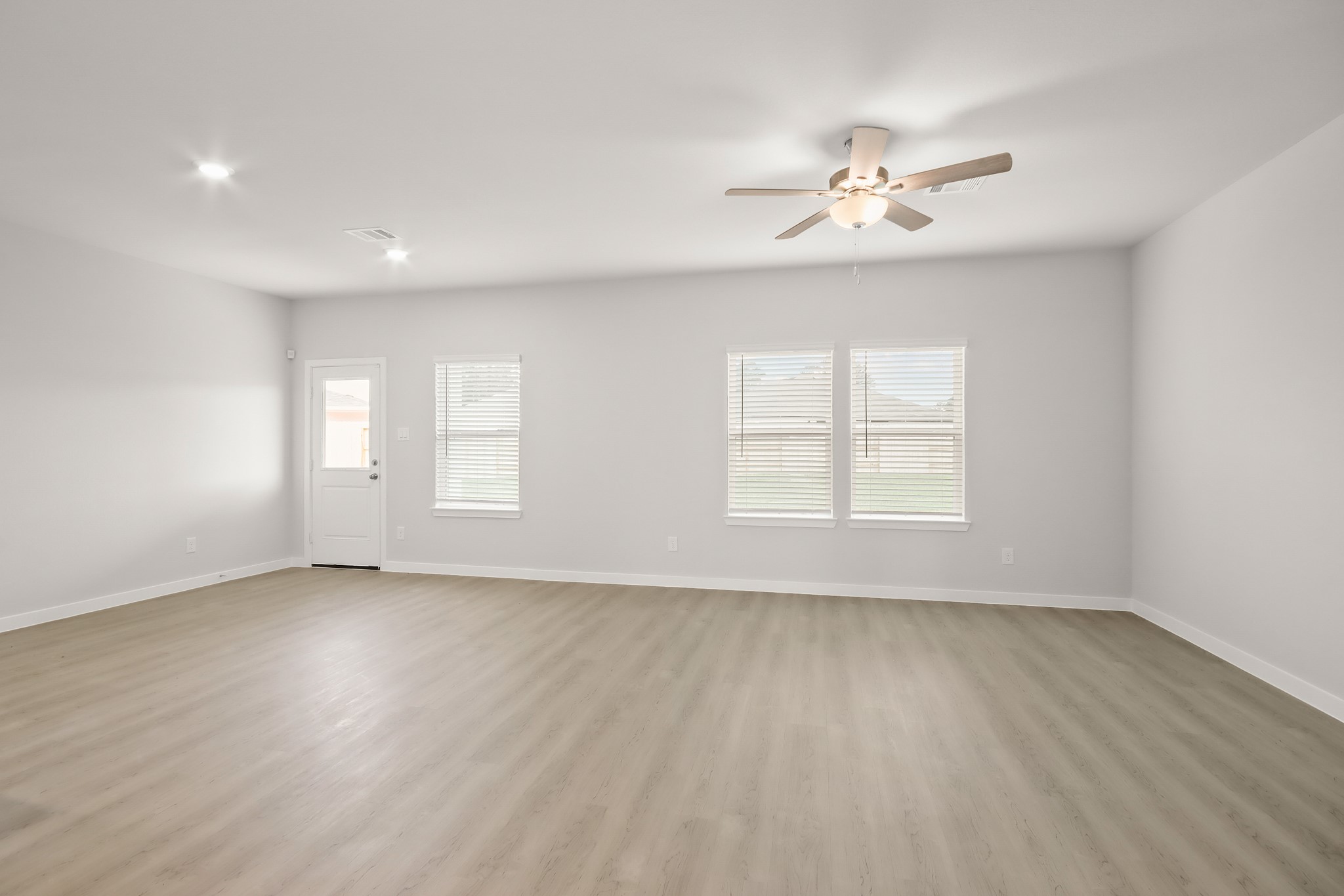 513 Wax Myrtle Way Hockley, TX 77447 - Photo 6 of 29 a view of an empty room with a window and wooden floor