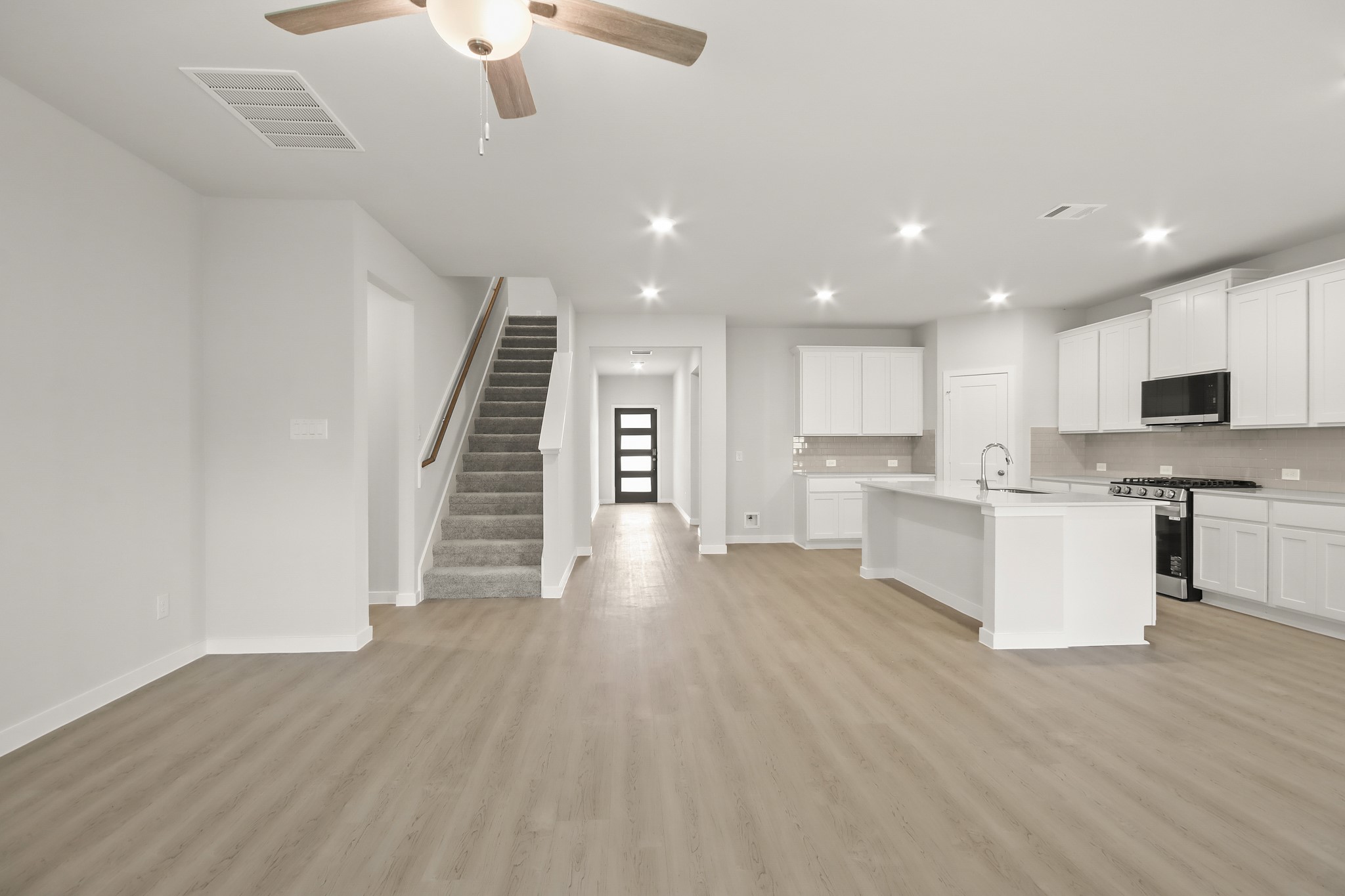 513 Wax Myrtle Way Hockley, TX 77447 - Photo 7 of 29 a view of a kitchen with wooden floor and electronic appliances