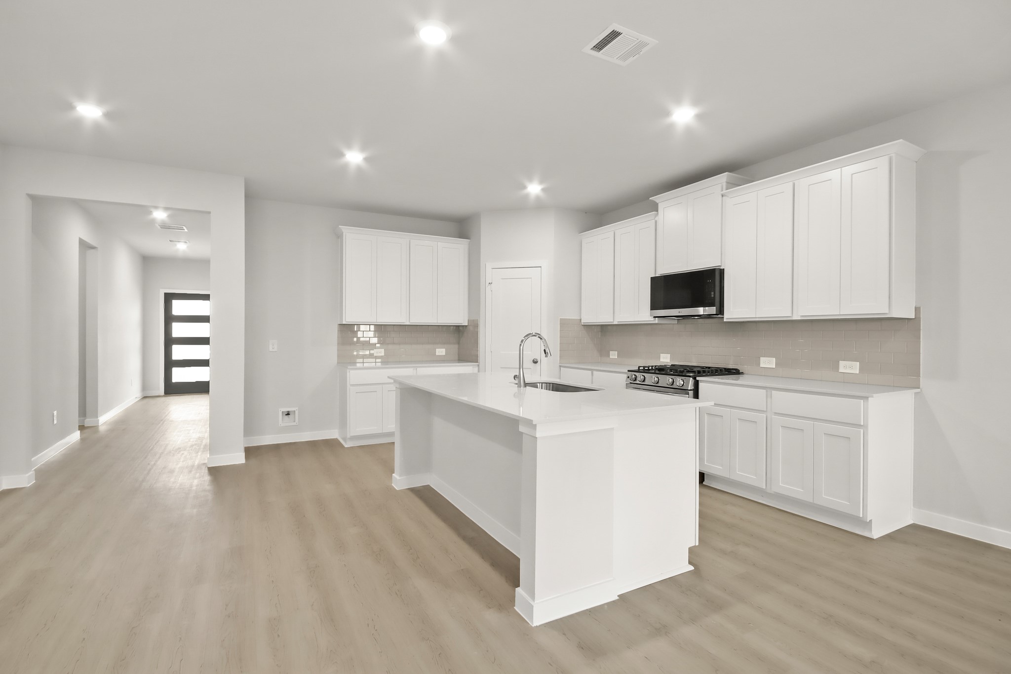 513 Wax Myrtle Way Hockley, TX 77447 - Photo 9 of 29 a kitchen with white cabinets and appliances
