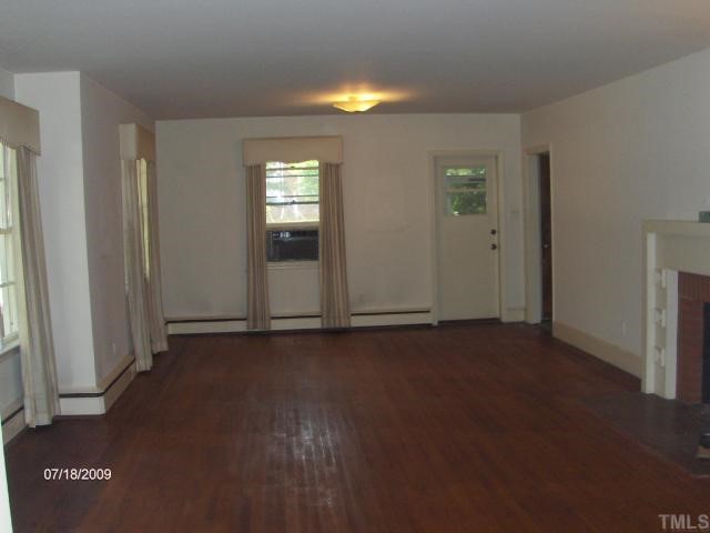 2700 Clark Avenue Raleigh, NC 27607 - Photo 4 of 9 an empty room with wooden floor and windows
