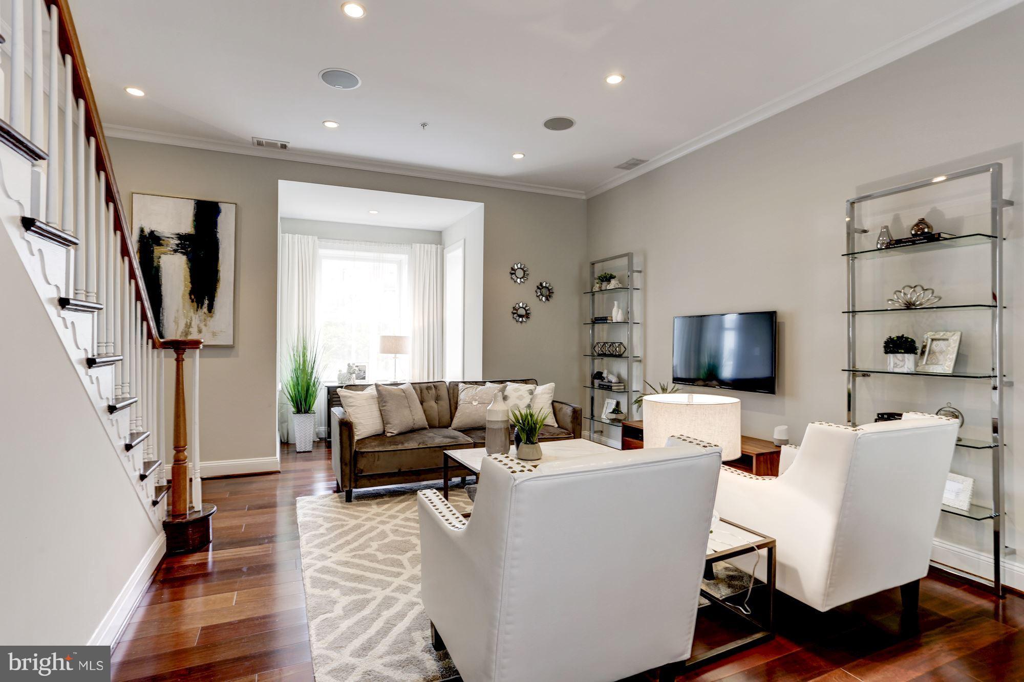 1229 12th Street Northwest, Unit 201 Washington, DC 20005 - Photo 12 of 29 a living room with furniture and a flat screen tv