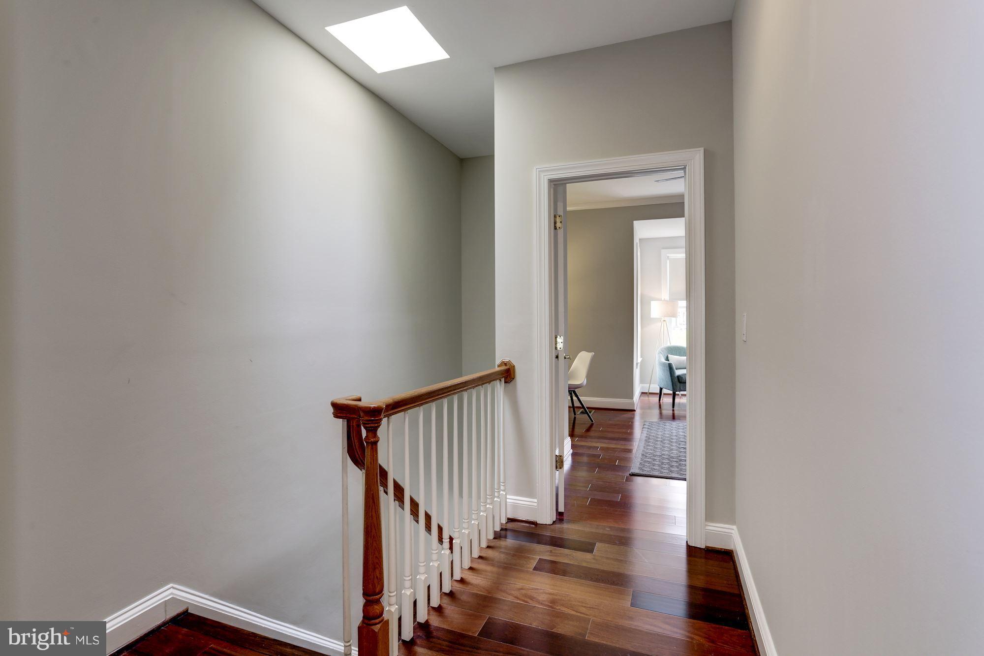 1229 12th Street Northwest, Unit 201 Washington, DC 20005 - Photo 15 of 29 a view of a hallway with wooden floor and staircase